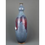 An unusual Chinese Zhun glazed pottery vase with ribbed and splashed decoration, H. 45cm.