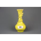 An early Chinese yellow glazed pottery vase relief decorated with a dragon. H.17.5cms. A/F