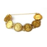 A 9ct (stamped 375) yellow gold bracelet set with six Victorian and Edwardian sovereigns, overall we