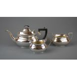 A three piece silver plated tea set, tea pot H. 16.5cm. Spout to handle W. 31cm.