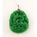 A Chinese carved jade/ hardstone dragon amulet on a 925 silver chain, amulet L. 5cm , chain L. 44cm.