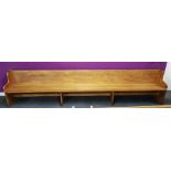 A large antique church pew, L. 367cm.