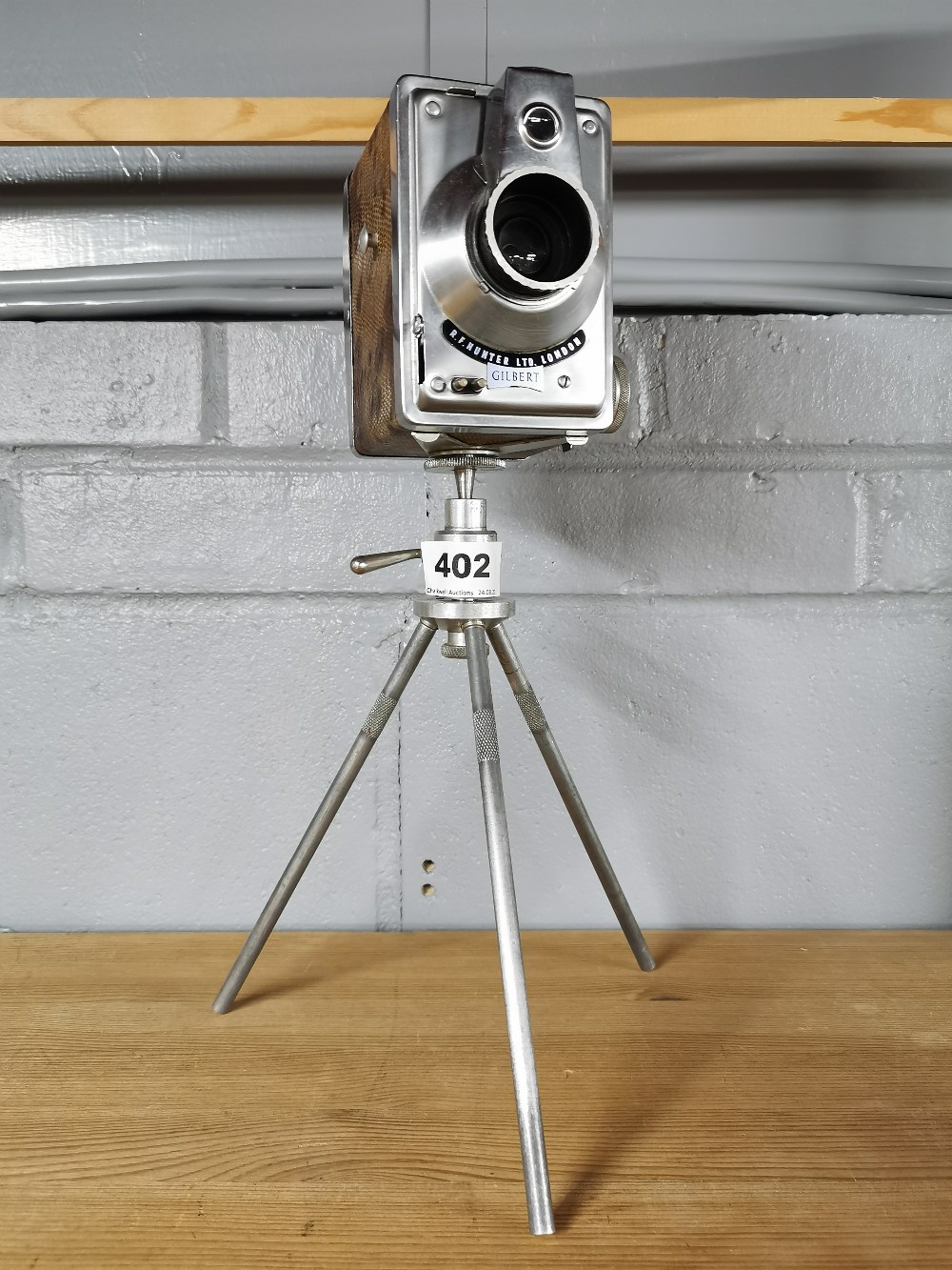 A vintage R.F. Hunter Ltd London Gilbert camera and tripod, overall H. 36cm.