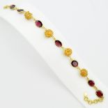 A 925 silver gilt bracelet set with oval cut garnets, L. 22cm.