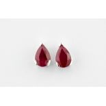 A pair of 9ct white gold stud earrings set with pear cut rubies, approx L. 4mm.