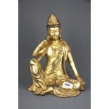 A Tibetan gilt bronze figure of a seated Deity, H. 33cm.