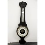 An ebonised carved wooden barometer, H. 84cm.