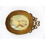 A fine gilt framed hand painted miniature of a young woman with a rose in her hair, frame H. 10cm.