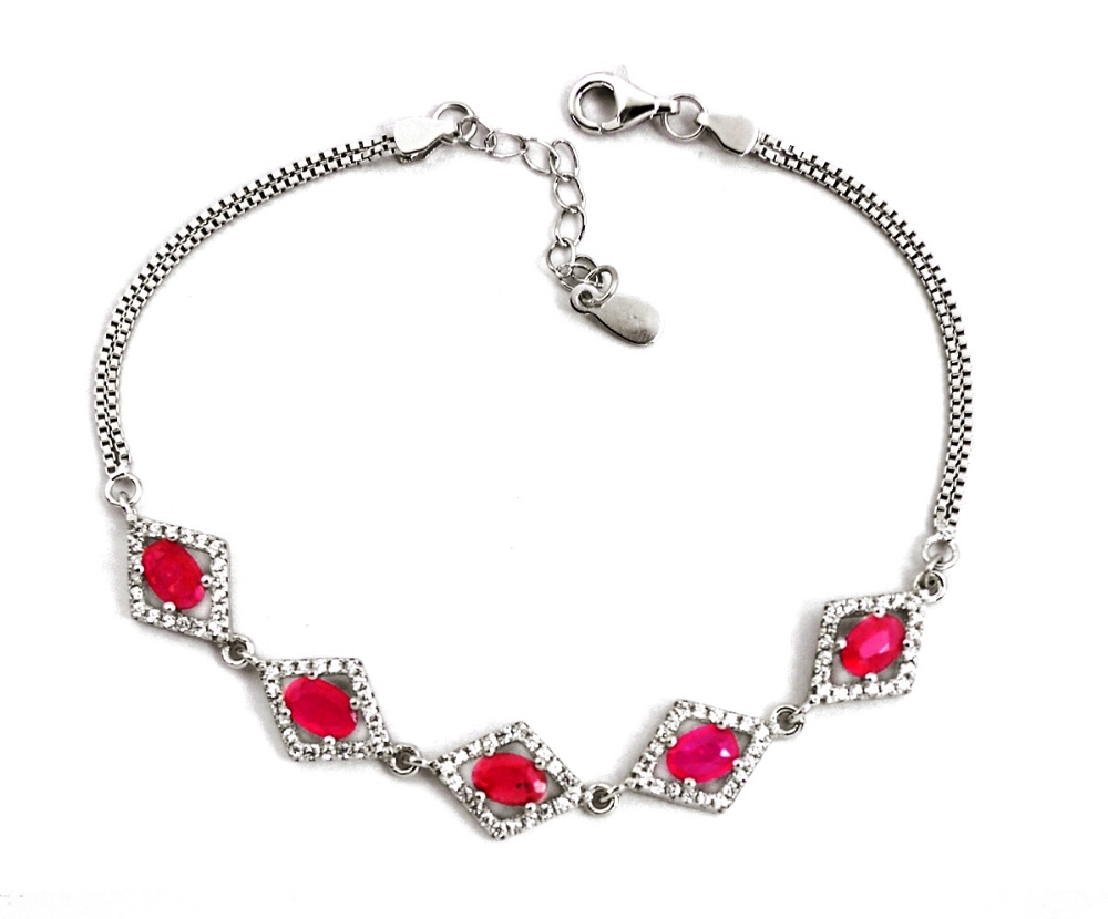 A 925 silver bracelet set with oval cut rubies and white stones, L. 18cm.