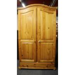 A pine two door wardrobe, W. 104cm. H. 183cm.