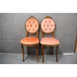 Two button backed boudoir chairs.