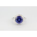 An 18ct (stamped 18k) white gold ring set with a round cut tanzanite, approx. 7ct, surrounded by
