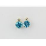 A pair of 9ct yellow gold blue topaz set stud earrings, L. 1cm.