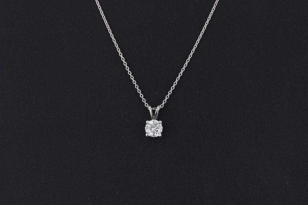 An 18ct white gold (stamped 750) pendant and chain set with a brilliant cut diamond, approx. 0.86ct,