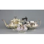 A relief decorated silver plated three piece tea set, teapot H. 15cm.