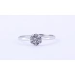 A 9ct white gold (stamped 375) cluster ring set with brilliant cut diamonds, (M.5).
