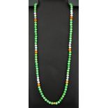 A single strand necklace of mixed colour jade beads, bead size 7.5mm. Necklace L. 80cm.