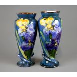 A pair of Devon ware Art Nouveau style flower decorated vases, H. 20cm. Condition : no visible