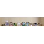 A collection of 11 glass paperweights, including Caithness.