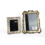 A hallmarked silver photo frame, H. 18cm, together with a silver plated photo frame.