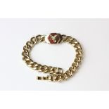 A 14ct (stamped 14k) heavy flat curb bracelet set with polished cut jasper and eagle decoration,