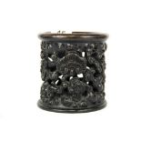 A Chinese carved and pierced dark wood brush pot decorated with ruyi shaped lotus leaves, H. 11cm,