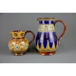 A Doulton Lambeth jug together with a Doulton Lambeth jug (possibly by Ethel Beard), H. 21 & 14cm.