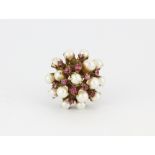 A 14ct yellow gold (stamped 14ct) pearl and pink stone set ring, one pearl missing, (O.5).