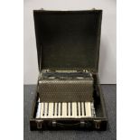 A cased vintage Hohner piano accordion.