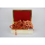 A quantity of old coral necklaces.