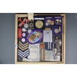 A tray of mixed military related items.