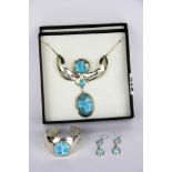 A boxed set of sterling silver necklace, bangle and earrings set with larimar.