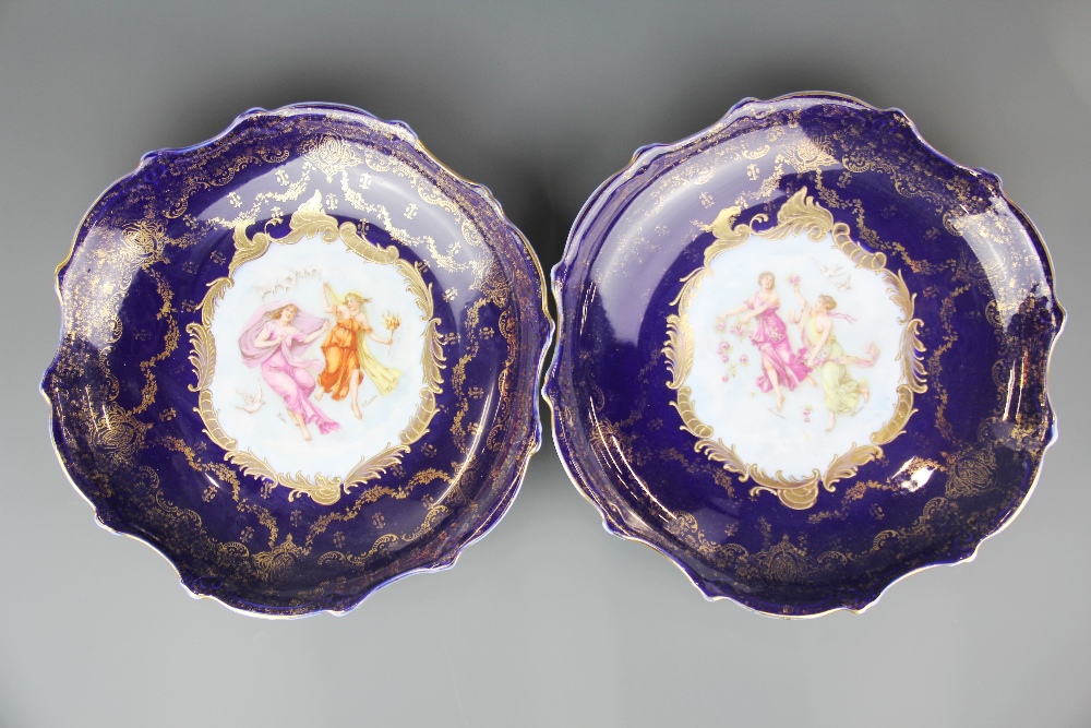 A pair of 19th Century Austrian gilt finished porcelain wall plates, Dia. 34cm.