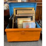 A metal travelling trunk with a quantity of framed pictures.