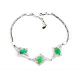 A 925 silver bracelet set with oval cut emeralds and white stones, L. 19cm.