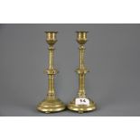A pair of ecclesiastical style brass candlesticks inset with semi precious stones, H. 22cm.