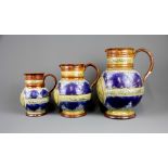 A set of three Queen Victoria diamond jubilee Doulton Lambeth stoneware jugs, two of them