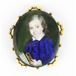 An early gilt metal framed portrait miniature of a boy painted in 1849 (details inked on the