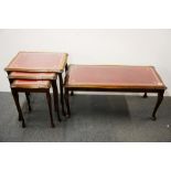 A leather and glass topped coffee table and a nest of three tables.