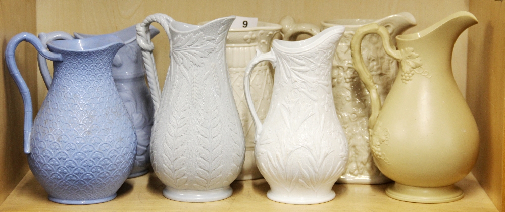Seven 19th Century relief decorated jugs, tallest H. 21.5cm.