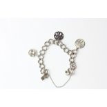 A sterling silver (approx. 25cm) flat curb bracelet with 3 assorted charms attached, a teacup and