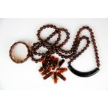 An unusual long amber bead necklace together with two amber bracelets.