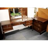 A dark teak Stag dressing table and matching chest of drawers.