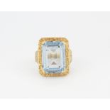 A 9ct yellow gold ring set with an emerald cut blue topaz, (O).