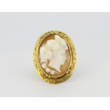 An early 9ct yellow gold (stamped 9ct) cameo set ring, L. 2.8cm, (M.5).
