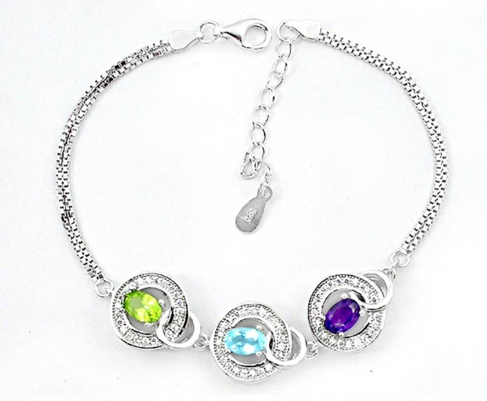 A 925 silver bracelet set with oval cut peridot, topaz and amethyst, L. 17cm.