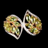 A 925 silver rose gold gilt ring set with marquise cut peridots and white stones, (Q).