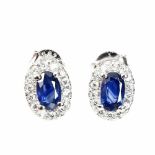 A pair of 925 silver cluster earrings set with a oval cut sapphires surrounded by white stones, L0.