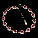 A 925 silver gilt bracelet set with oval cut rubies and white stones, L. 17cm