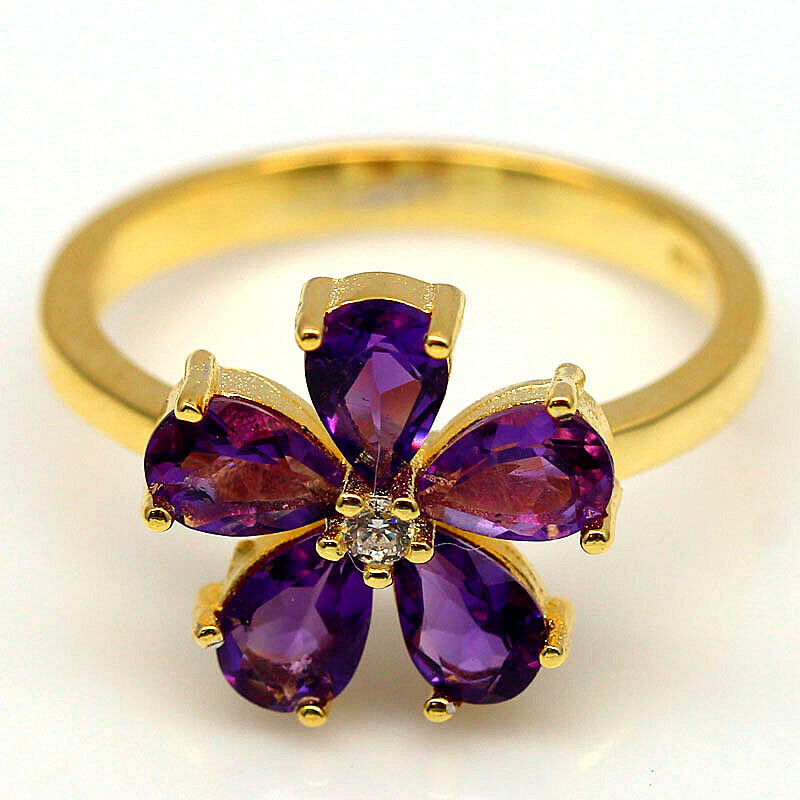 A pair of 925 silver gilt flower shaped rings et with amethyts, (P.5).